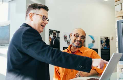 Accountant and small business owner reviewing tax information.