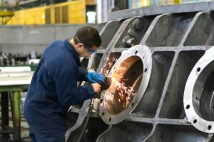 Man welding window frame.